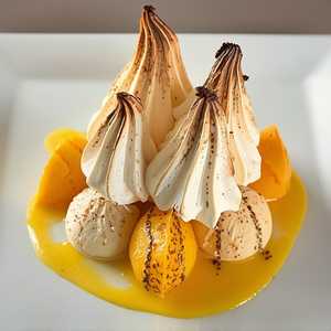 Baked Alaska with Coconut Sorbet, Mango Sorbet, Vanilla Sponge, and Passion Fruit Sauce