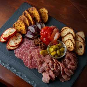 charcuterie board, pickles, mustard, grilled bread