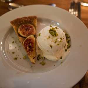 Warm fig-frangipane tart with yogurt ice cream and pistachios