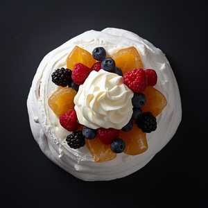 Berry pavlova with crème Chantilly and candied tangelo