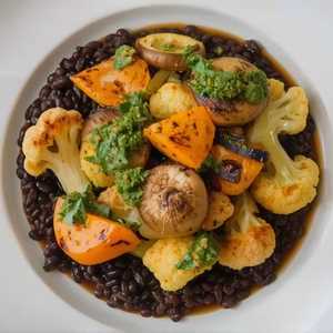 Honeynut squash, sprouting cauliflower, and chanterelle mushrooms with slow-braised black lentils and fried sage-walnut pesto