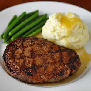 Grilled 9 oz. Ribeye Steak* With Garlic Butter And Mashed Potatoes