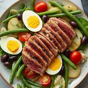 Niçoise: seared ahi tuna or salmon, olives, peppers, green beans, potatoes, eggs, tomatoes, artichoke hearts, radishes, anchovies, whole grain mustard, sherry vinaigrette