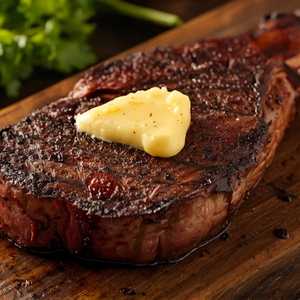 Kona-Crusted Dry Aged Bone-In NY Strip with Shallot Butter