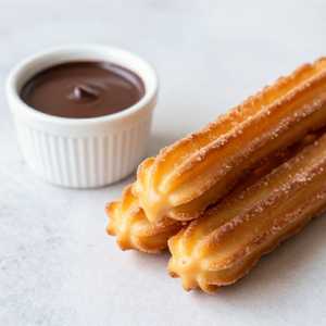 Churro Filled With Dulce De Leche And Hot Chocolate Served With Vanilla Foam