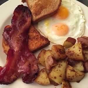 DOS HUEVOS FRITOS O REVUELTOS CON JAMON, O SALCHICHA O BACON OF COURSE PAPA DE LA CASA
